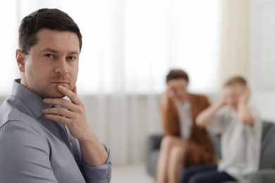 Photo of Thoughtful psychologist having consultation in office, selective focus