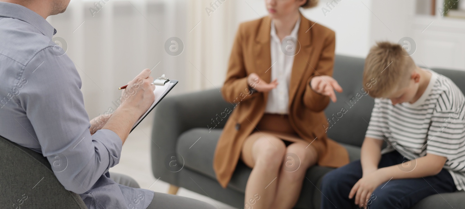 Mother and son having consultation with psychologist in office, selective focus Photo of Mother and son having consultation with psychologist in office, selective focus
