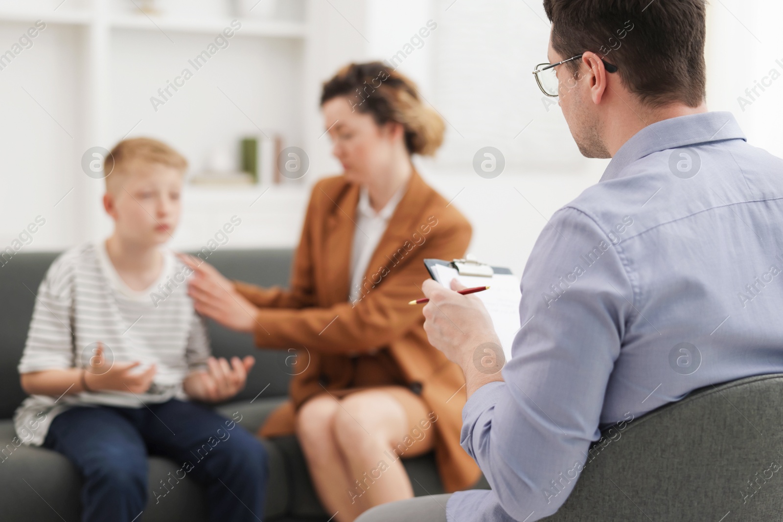 Mother and son having consultation with psychologist in office, selective focus Photo of Mother and son having consultation with psychologist in office, selective focus