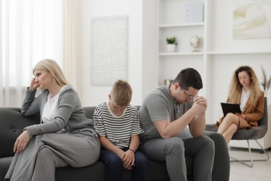 Photo of Offended family during consultation with psychologist in office, selective focus