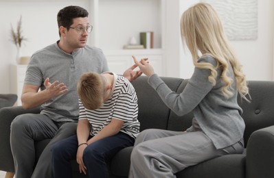 Photo of Family arguing during consultation with psychologist in office, selective focus