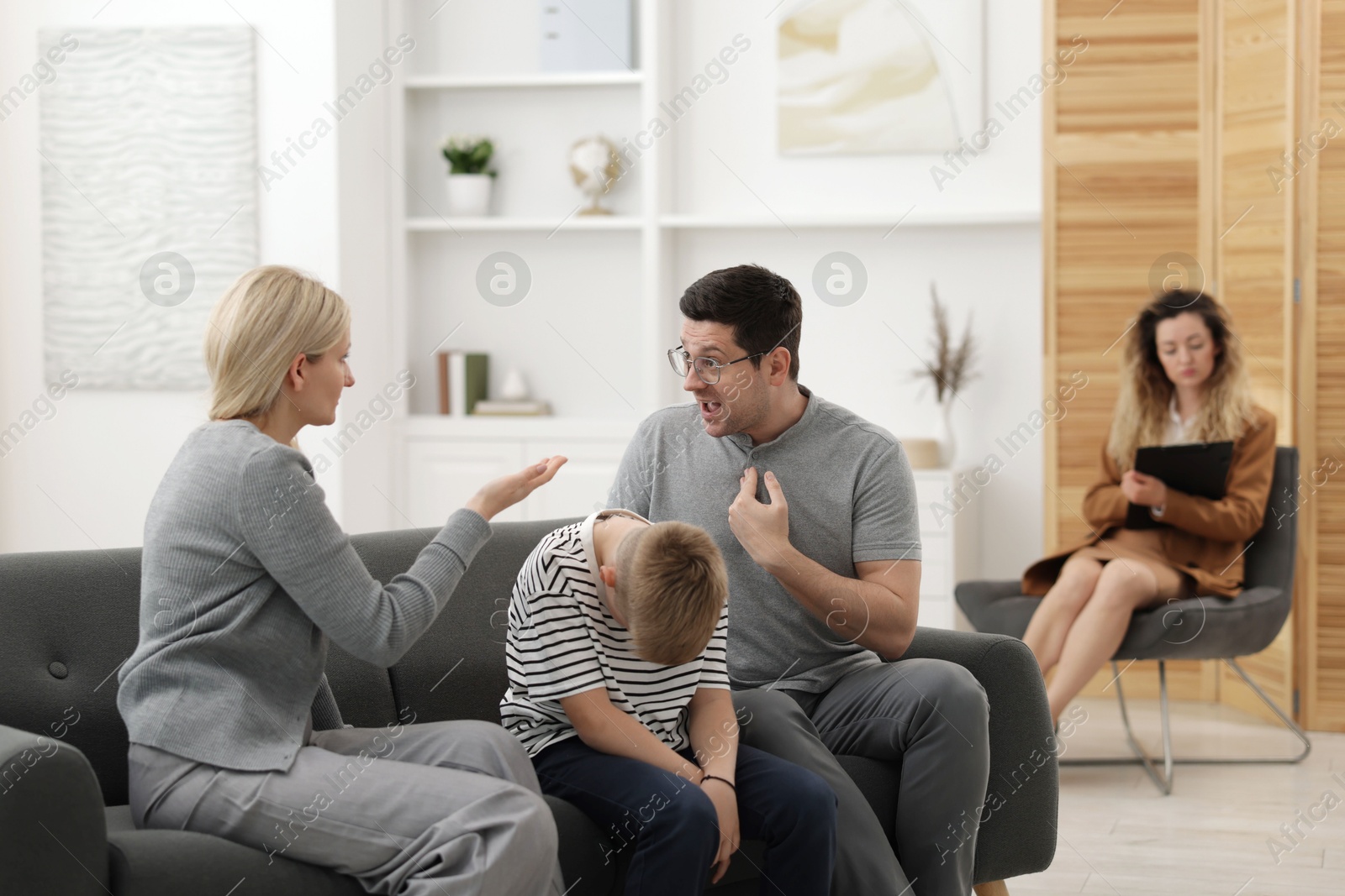 Family arguing during consultation with psychologist in office, selective focus Photo of Family arguing during consultation with psychologist in office, selective focus