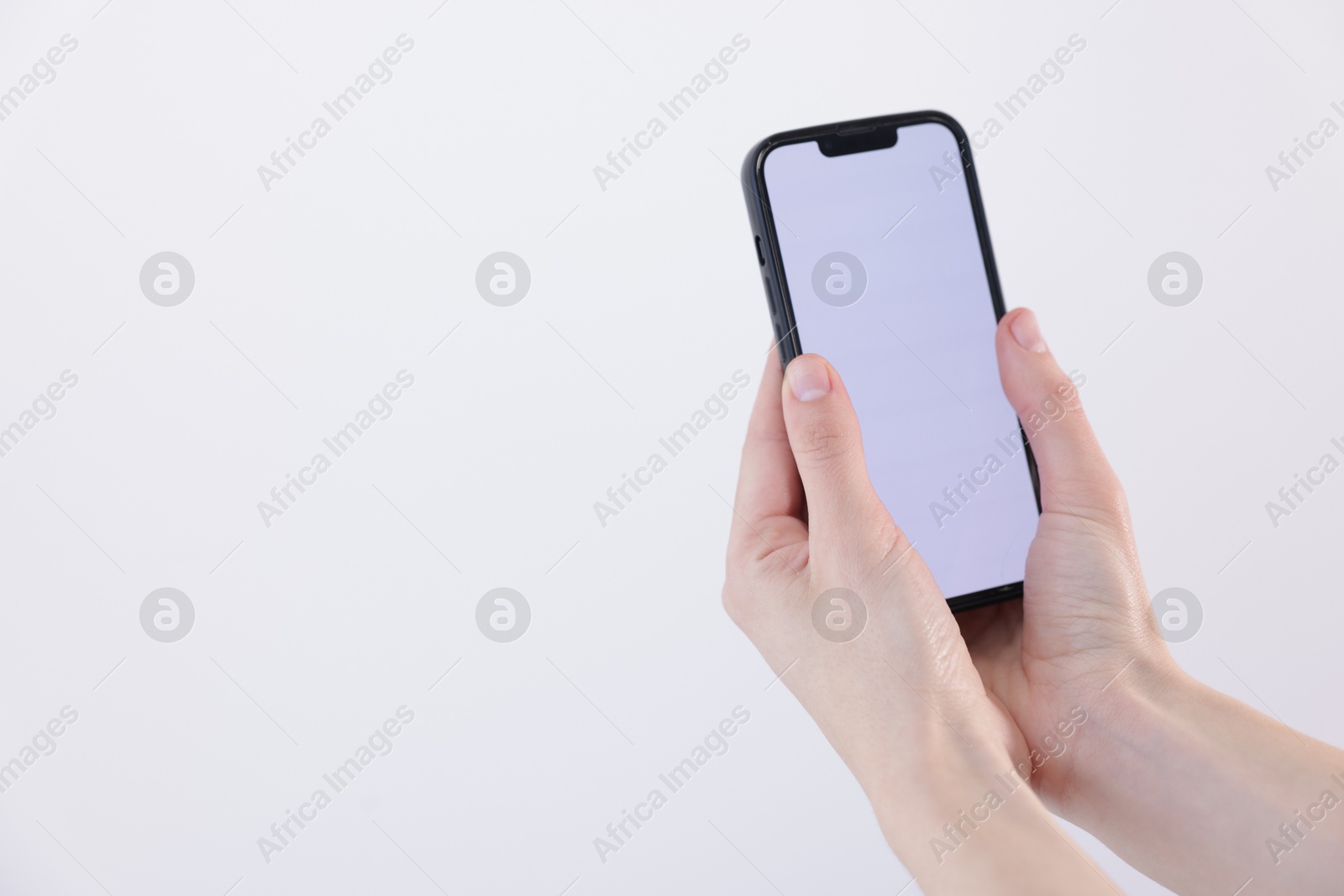 Woman holding smartphone with blank screen on white background, closeup. Mockup for design Photo of Woman holding smartphone with blank screen on white background, closeup. Mockup for design