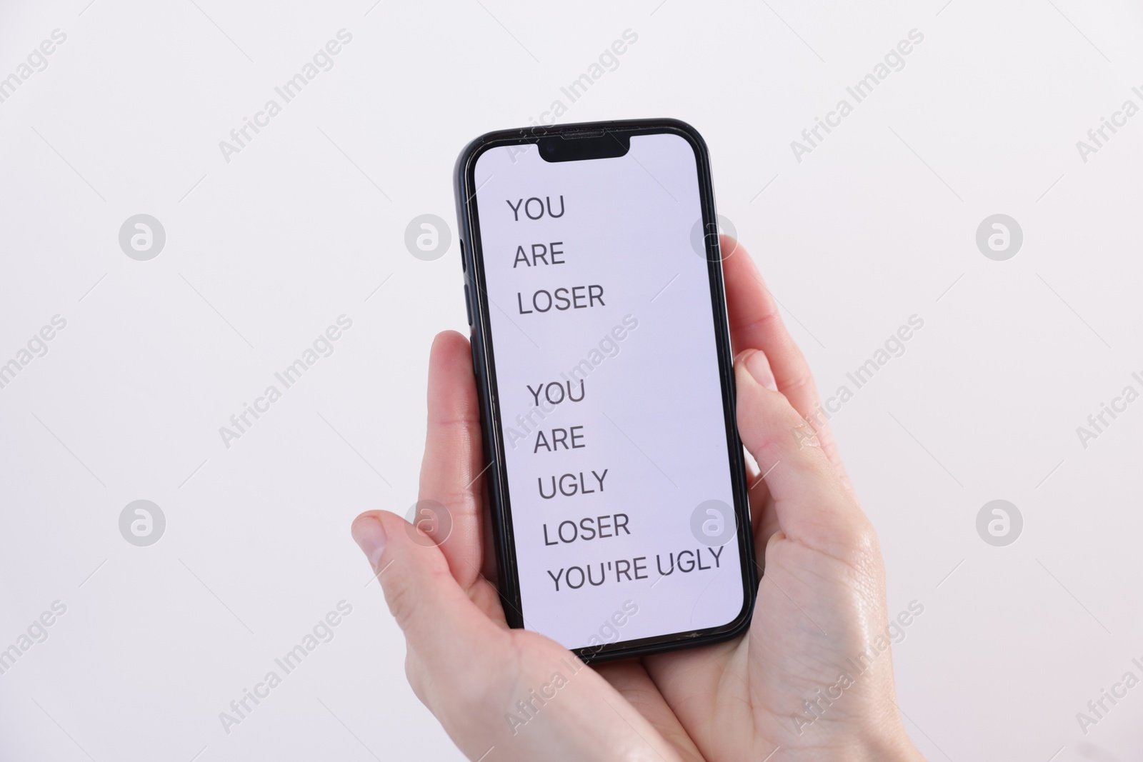 Cyber bullying. Woman holding smartphone with insults on light background, closeup Photo of Cyber bullying. Woman holding smartphone with insults on light background, closeup