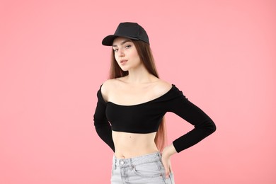 Photo of Portrait of beautiful woman in stylish baseball hat on pink background