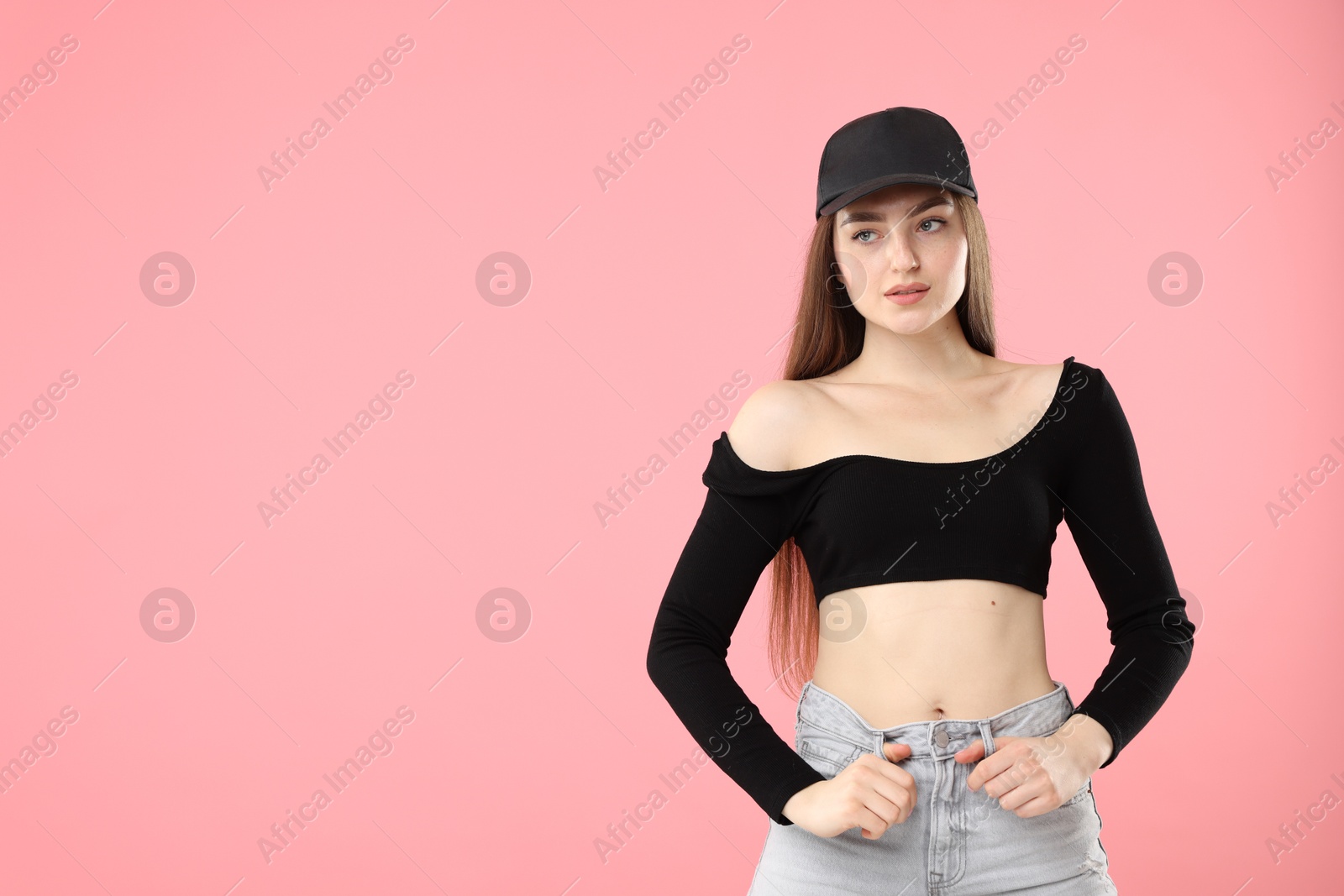 Portrait of beautiful woman in stylish baseball hat on pink background. Space for text Photo of Portrait of beautiful woman in stylish baseball hat on pink background. Space for text