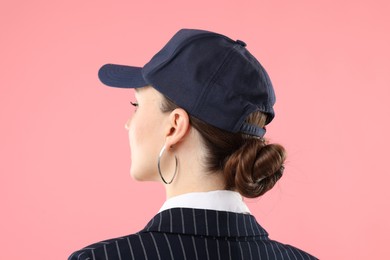 Photo of Woman in stylish baseball hat on pink background