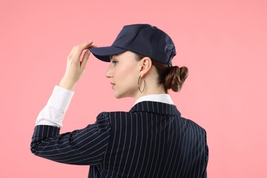 Photo of Woman in stylish baseball hat on pink background