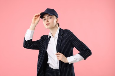 Photo of Portrait of beautiful woman in stylish baseball hat on pink background