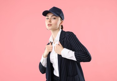 Photo of Portrait of beautiful woman in stylish baseball hat on pink background