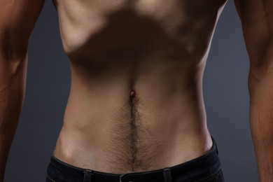 Photo of Man suffering from anorexia on grey background, closeup