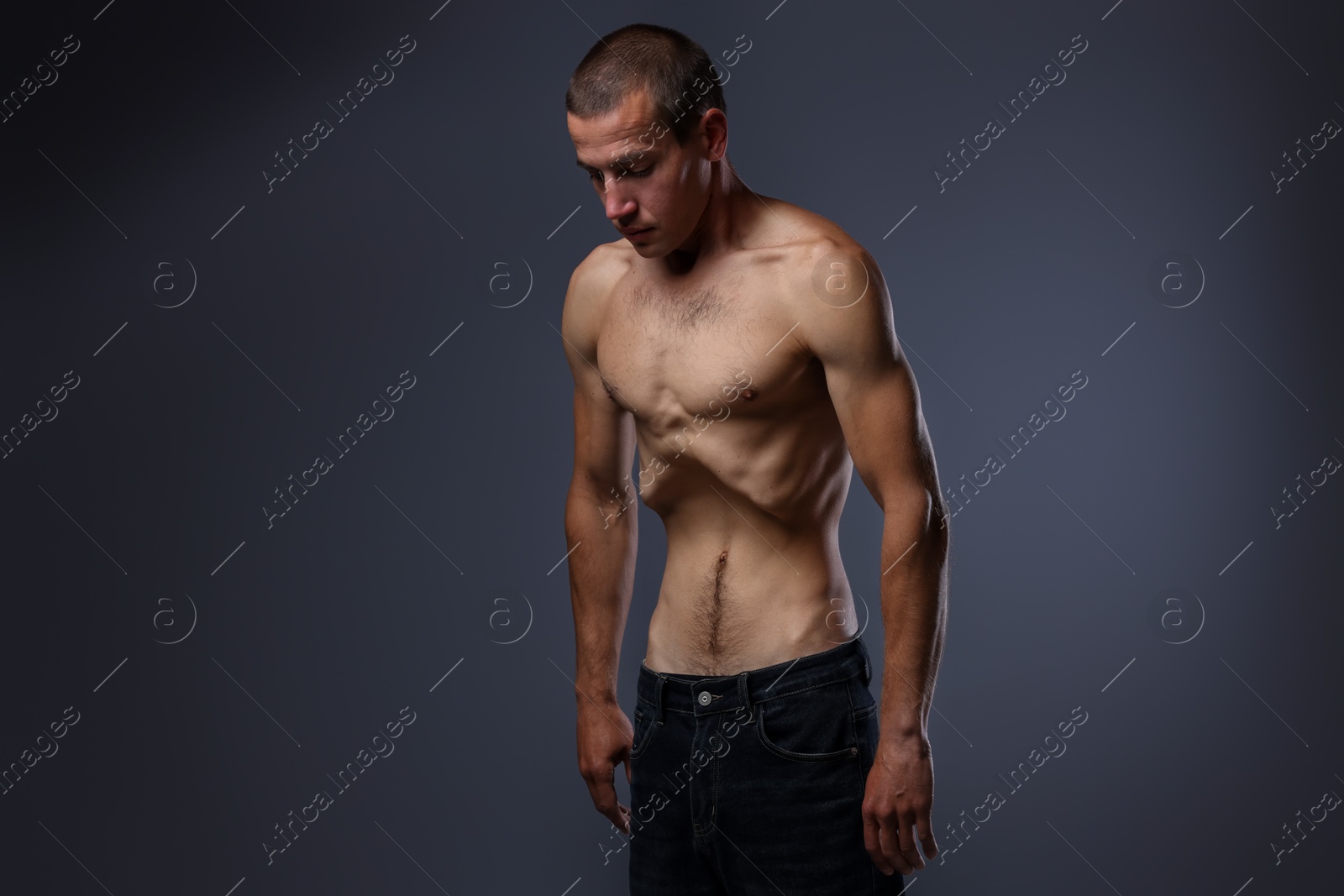 Man suffering from anorexia on grey background Photo of Man suffering from anorexia on grey background