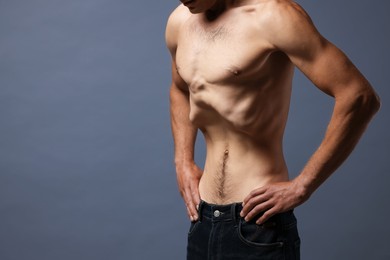 Photo of Man suffering from anorexia on grey background, closeup. Space for text