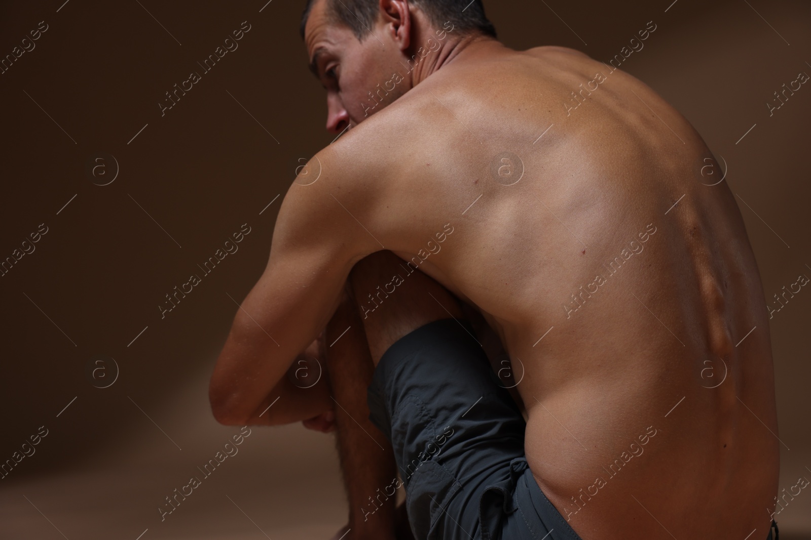 Man suffering from anorexia on beige background, closeup Photo of Man suffering from anorexia on beige background, closeup
