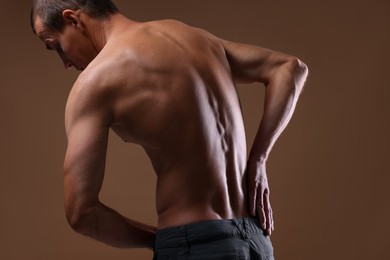 Photo of Man suffering from anorexia on beige background, closeup