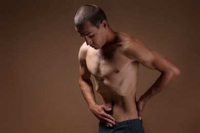 Photo of Man suffering from anorexia on beige background. Space for text