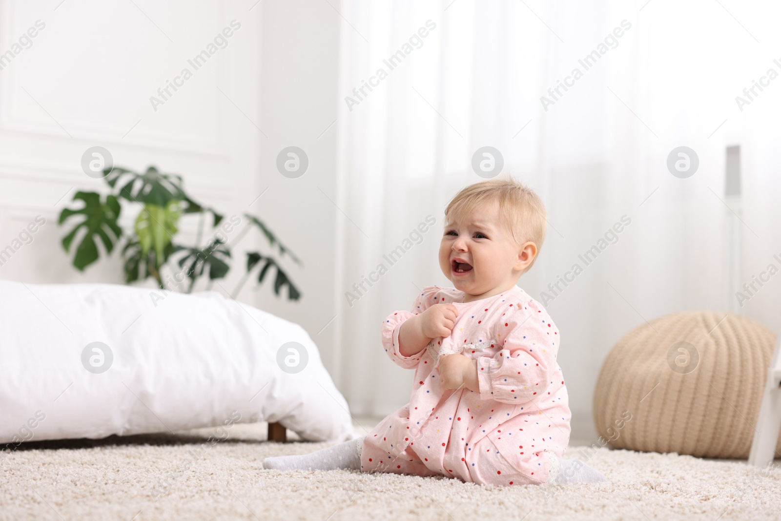 Cute little baby girl crying at home Photo of Cute little baby girl crying at home