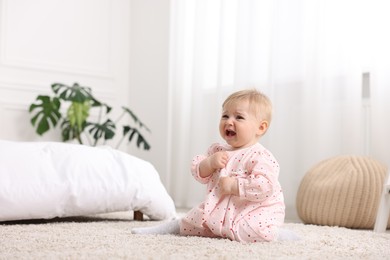 Photo of Cute little baby girl crying at home