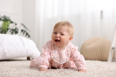 Photo of Cute little baby girl crying at home