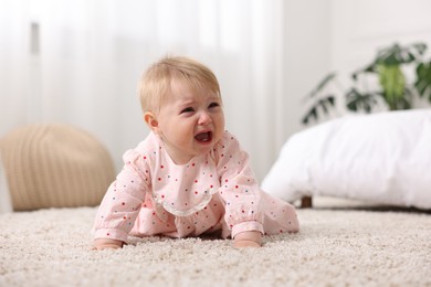 Photo of Cute little baby girl crying at home