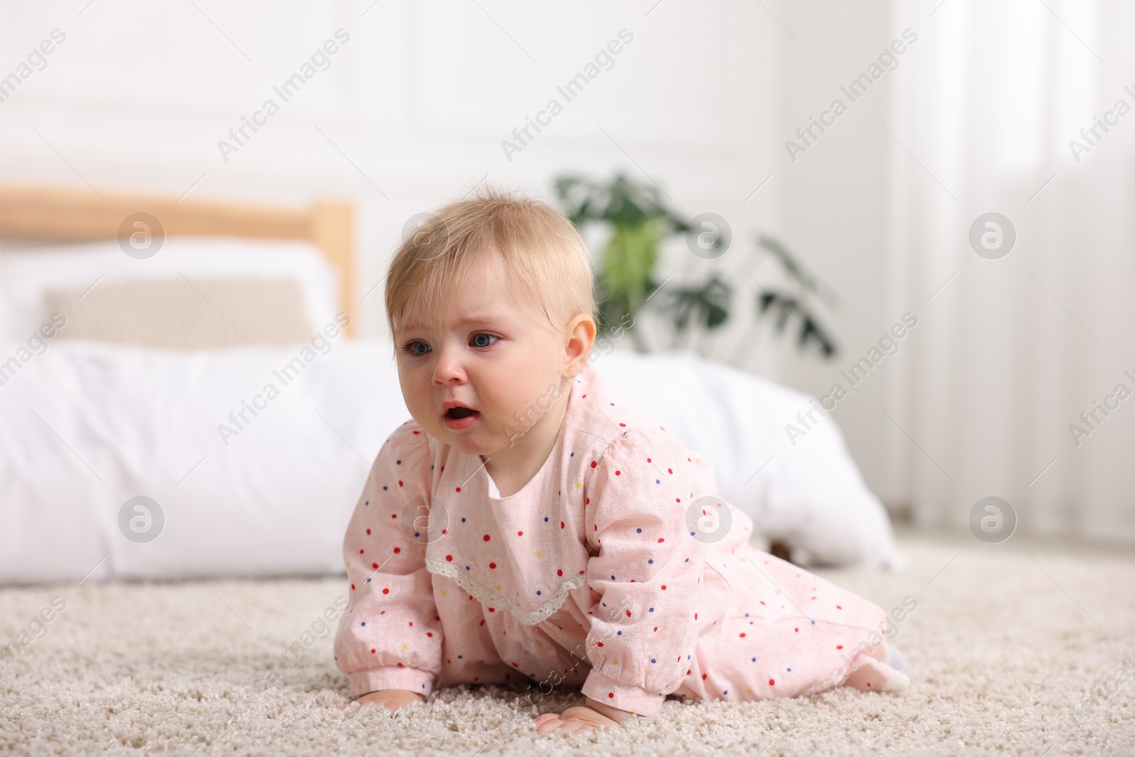 Cute little baby girl crying at home Photo of Cute little baby girl crying at home