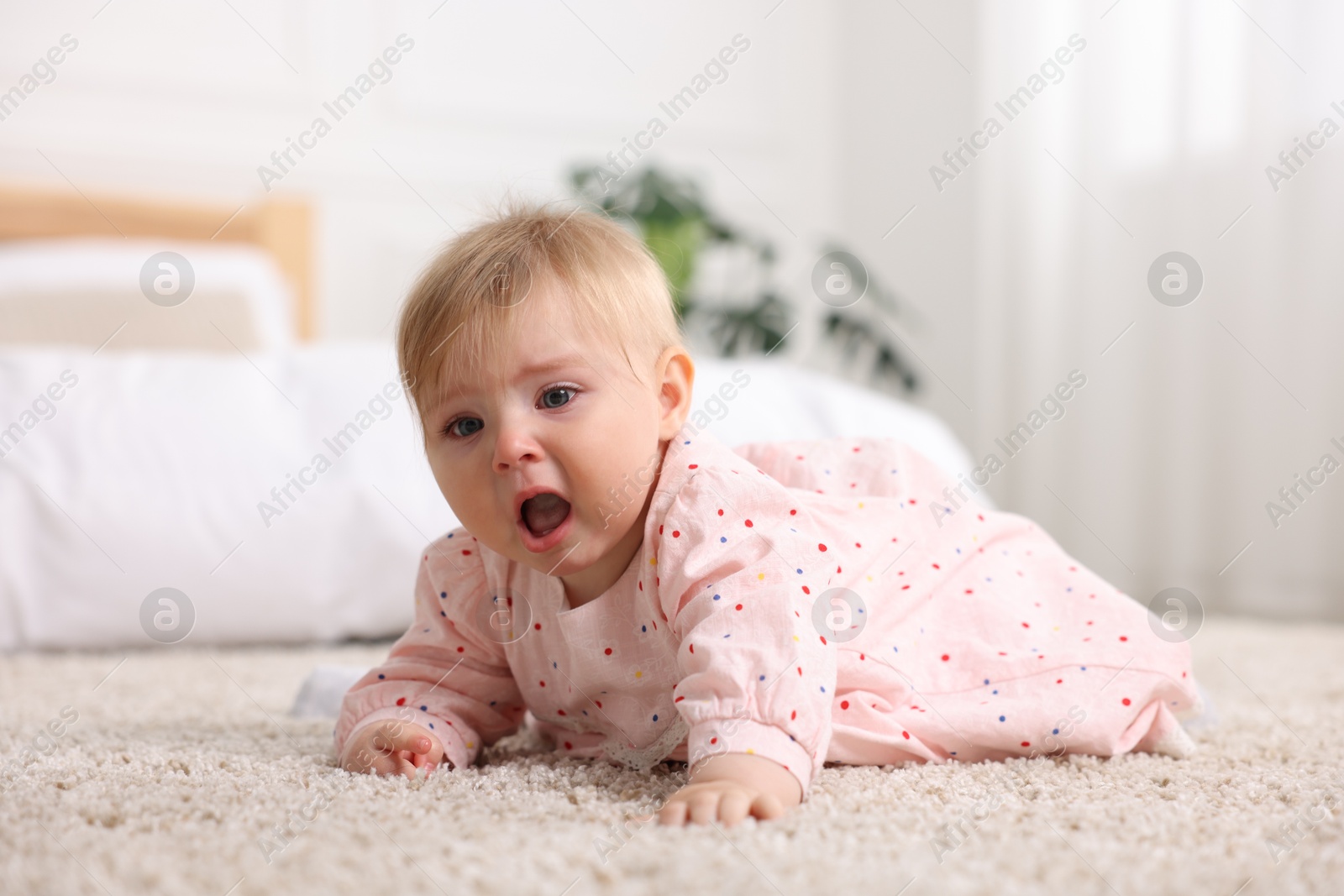 Cute little baby girl crying at home Photo of Cute little baby girl crying at home