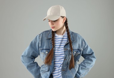 Photo of Woman in stylish baseball hat on grey background