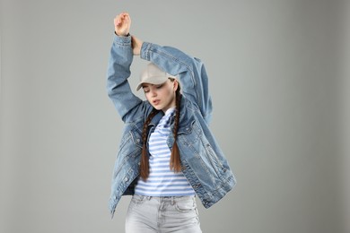 Photo of Beautiful woman in stylish baseball hat on grey background
