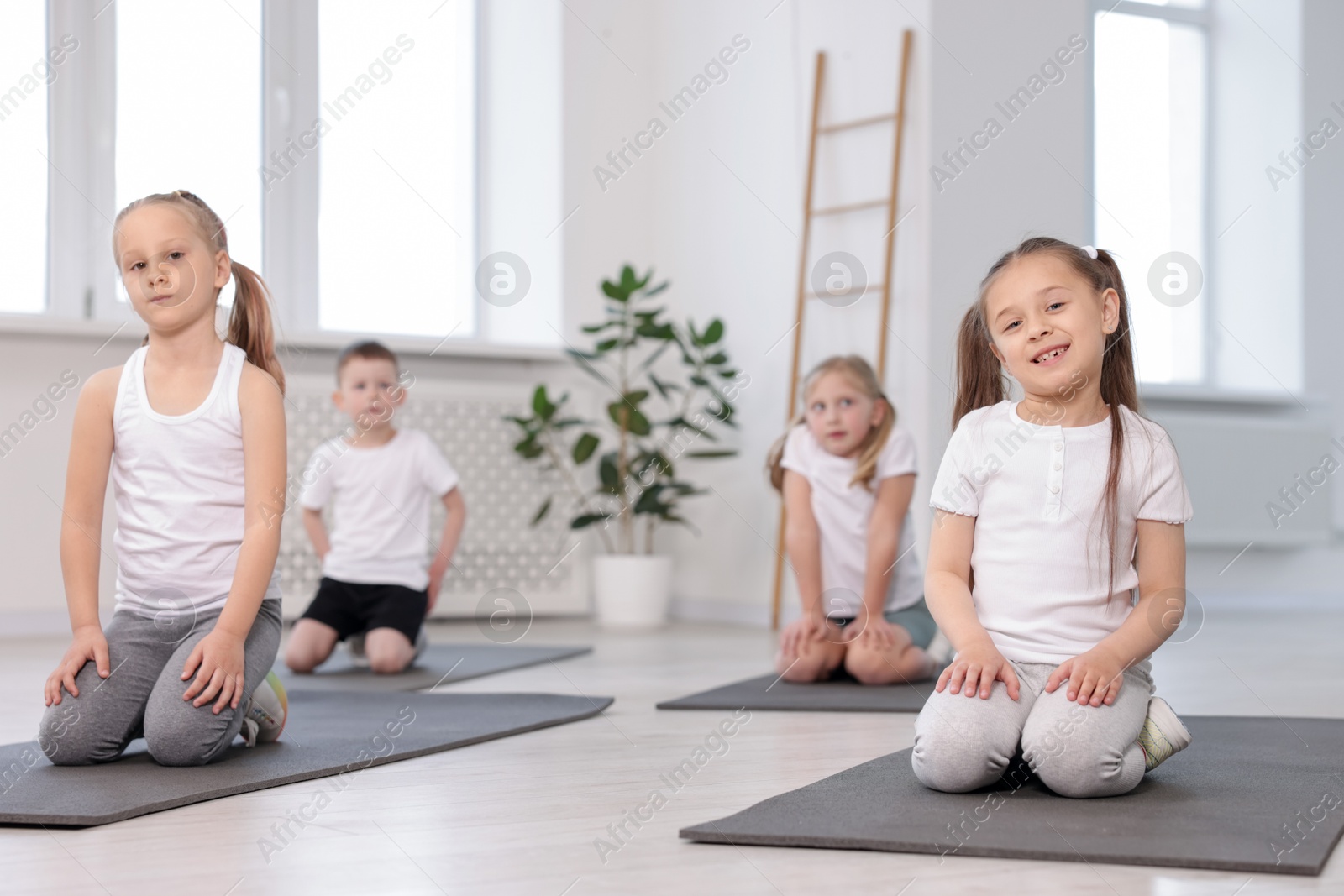 Group of children on yoga mats in class Photo of Group of children on yoga mats in class
