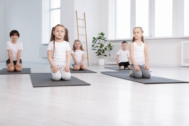 Photo of Group of children on yoga mats in class