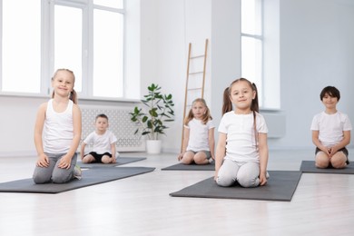 Photo of Group of children on yoga mats in class