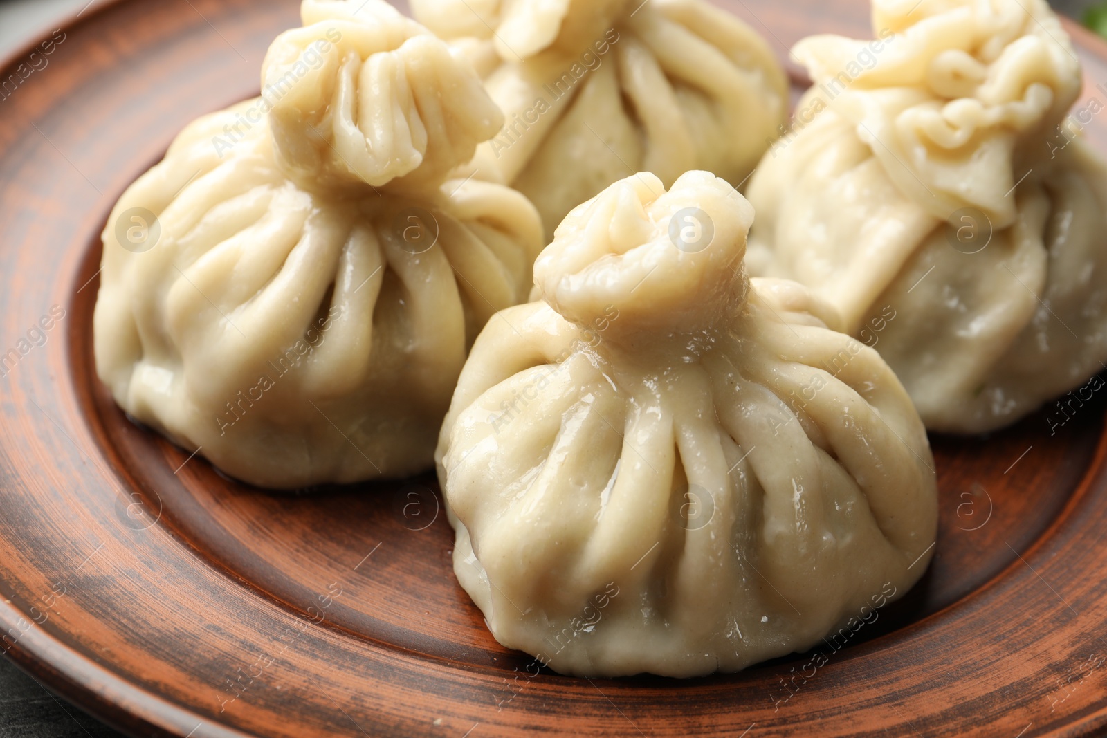 Delicious cooked khinkali served on table, closeup Photo of Delicious cooked khinkali served on table, closeup
