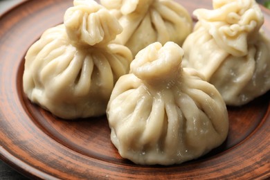 Photo of Delicious cooked khinkali served on table, closeup