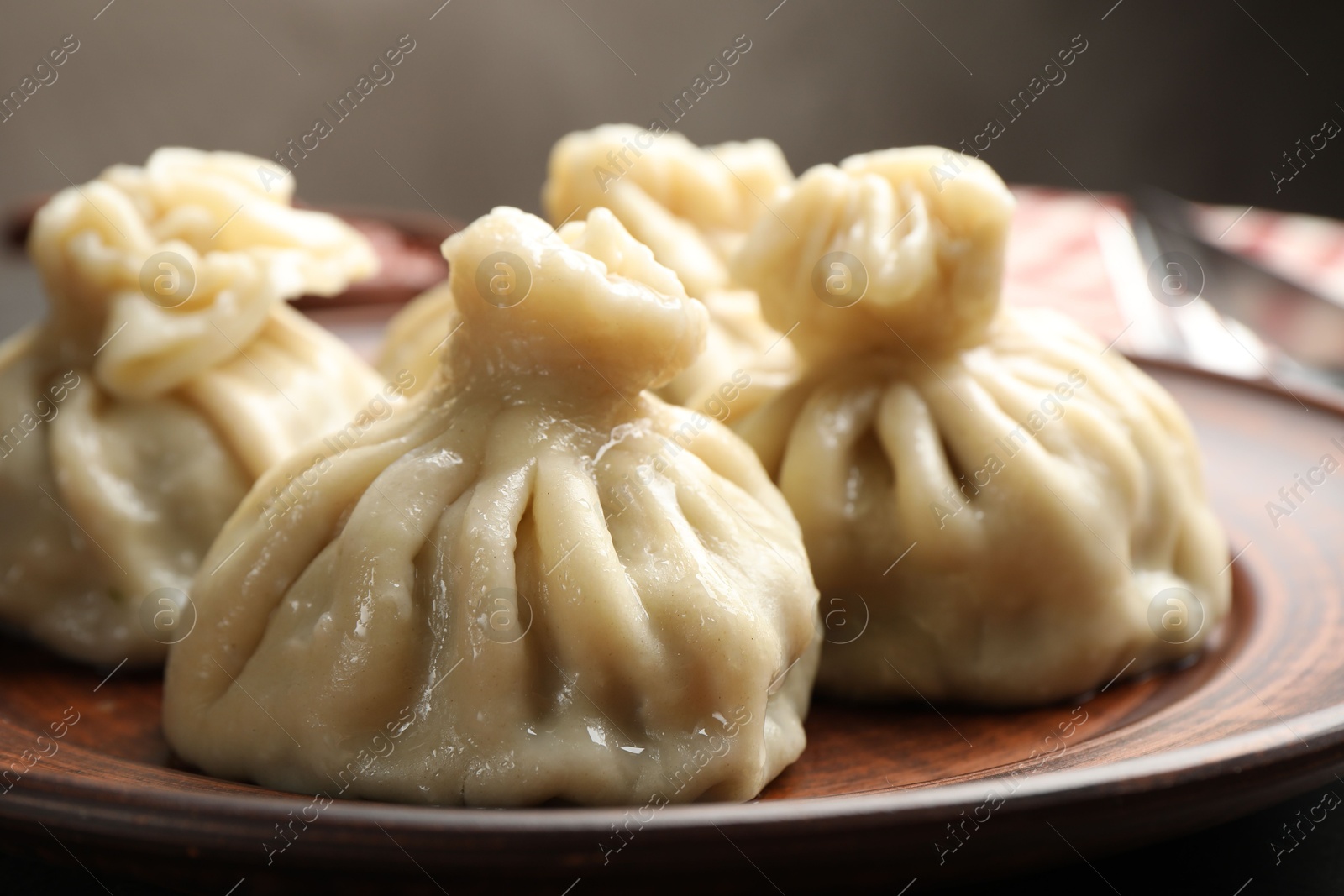 Delicious cooked khinkali served on table, closeup Photo of Delicious cooked khinkali served on table, closeup