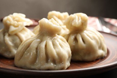 Photo of Delicious cooked khinkali served on table, closeup