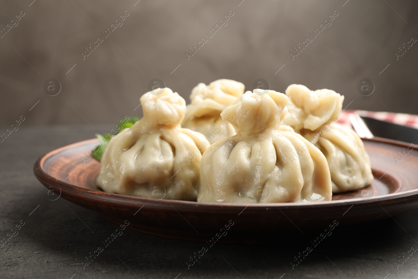 Delicious khinkali served on grey table, closeup Photo of Delicious khinkali served on grey table, closeup