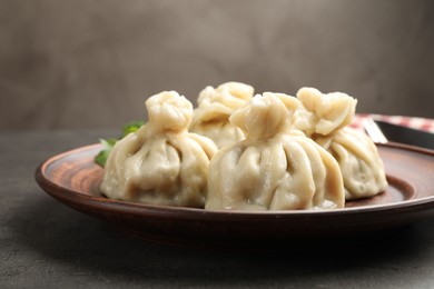 Photo of Delicious khinkali served on grey table, closeup