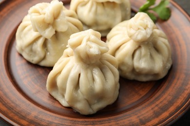 Photo of Delicious cooked khinkali served on table, closeup