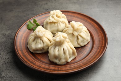 Photo of Delicious khinkali served on grey table, closeup