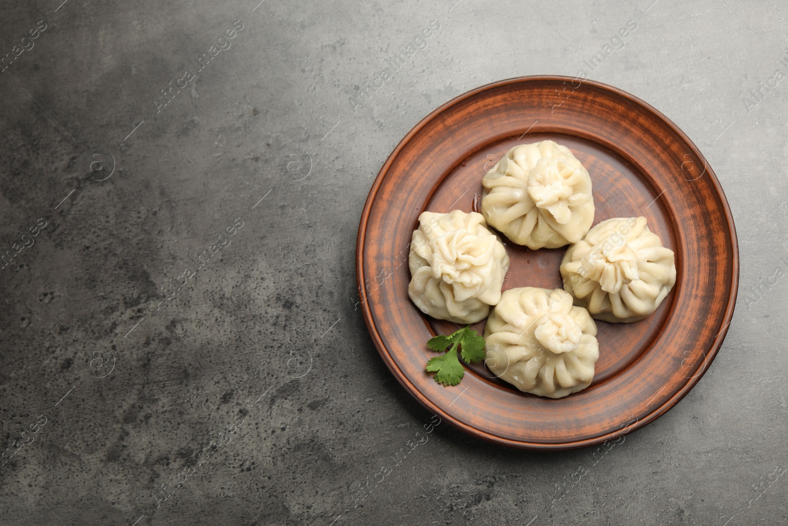 Delicious khinkali served on grey table, top view. Space for text Photo of Delicious khinkali served on grey table, top view. Space for text
