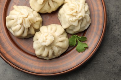 Photo of Delicious khinkali served on grey table, top view