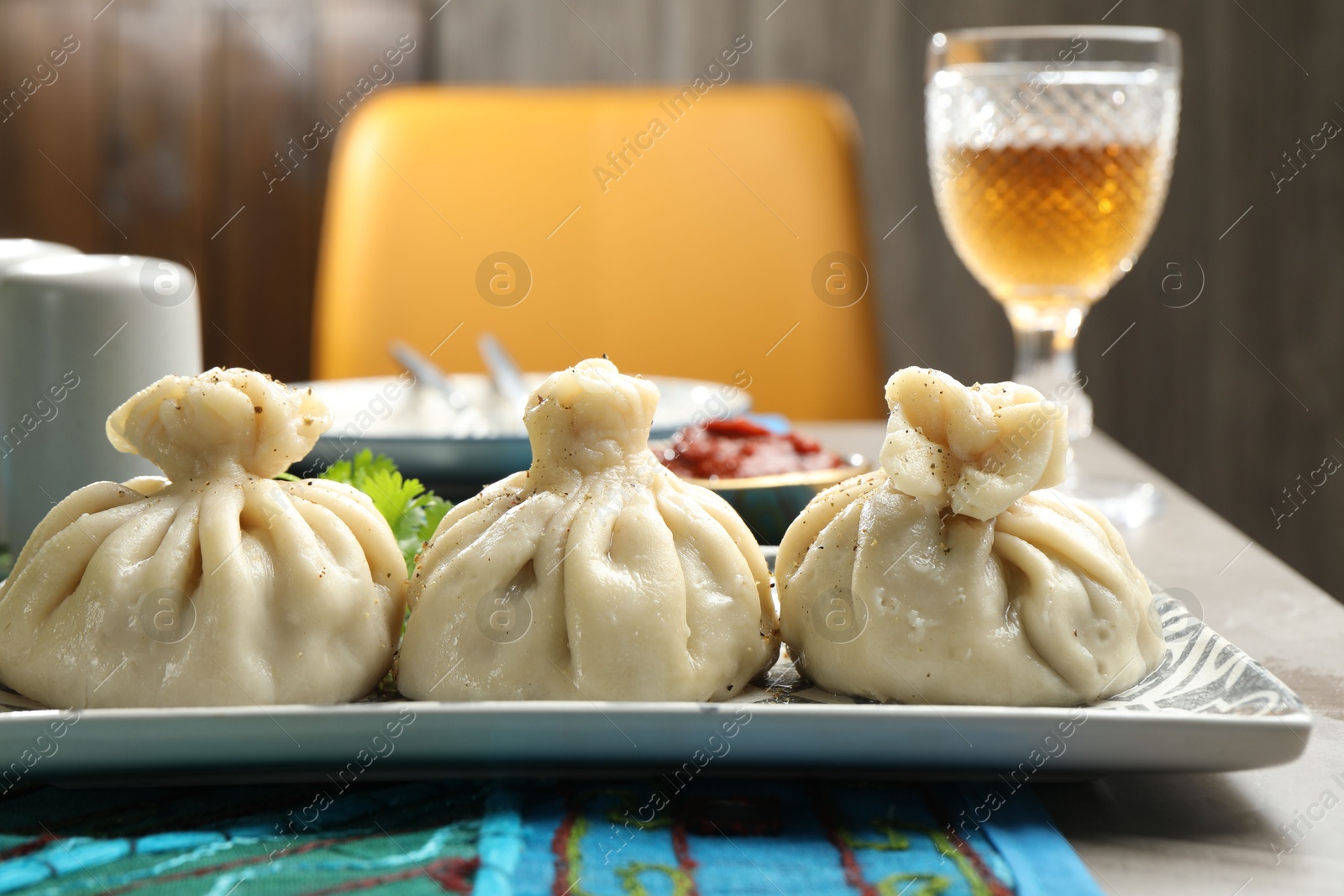 Delicious khinkali served on grey table, closeup Photo of Delicious khinkali served on grey table, closeup