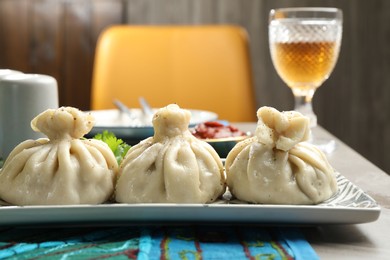 Photo of Delicious khinkali served on grey table, closeup