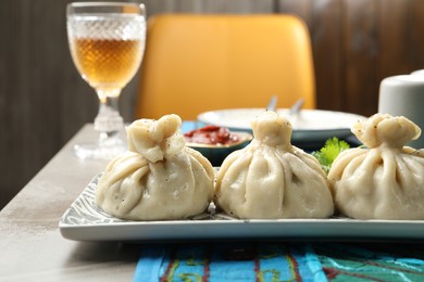 Photo of Delicious khinkali served on grey table, closeup