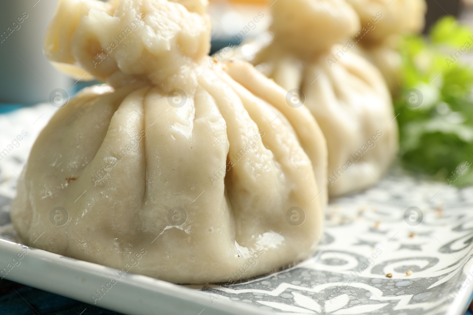 Delicious cooked khinkali served on table, closeup Photo of Delicious cooked khinkali served on table, closeup