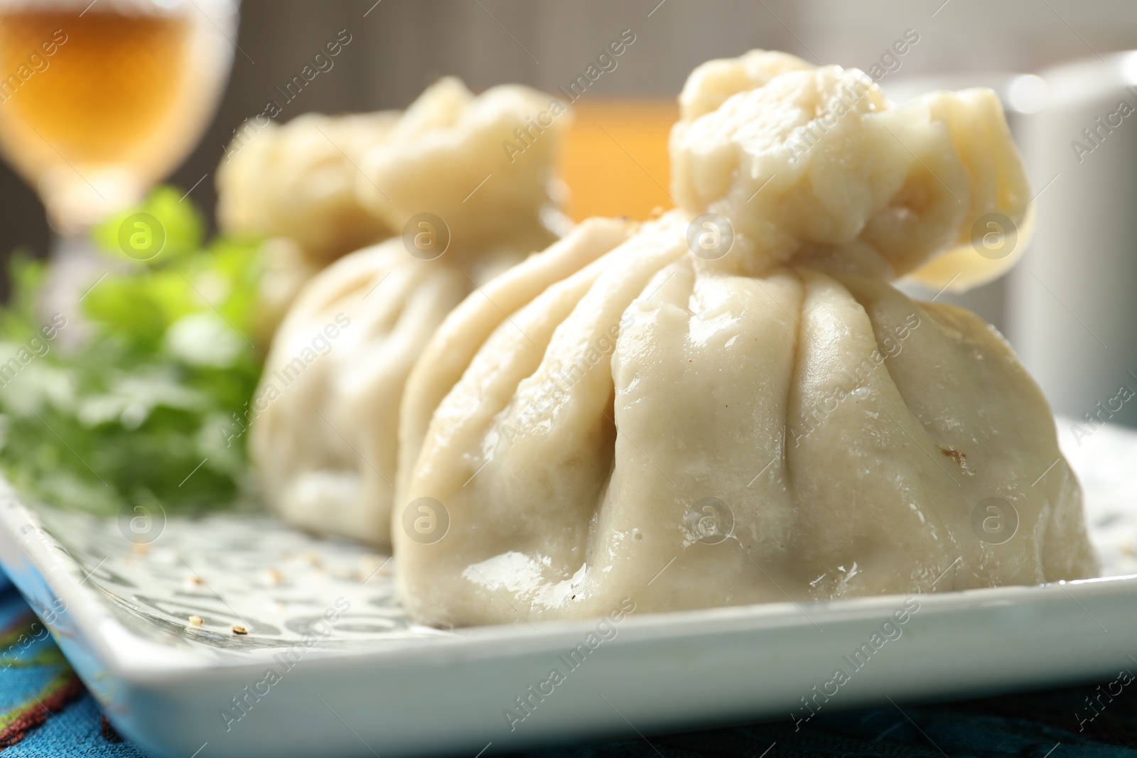 Delicious cooked khinkali served on table, closeup Photo of Delicious cooked khinkali served on table, closeup