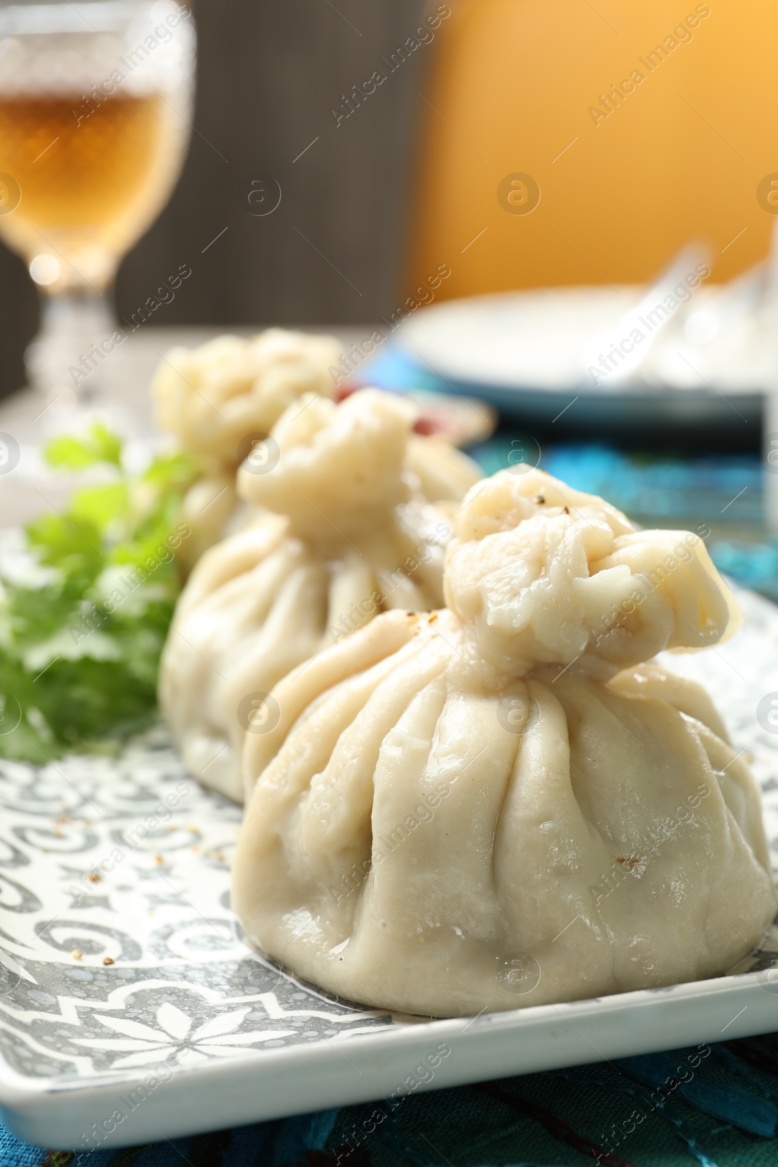 Delicious cooked khinkali served on table, closeup Photo of Delicious cooked khinkali served on table, closeup