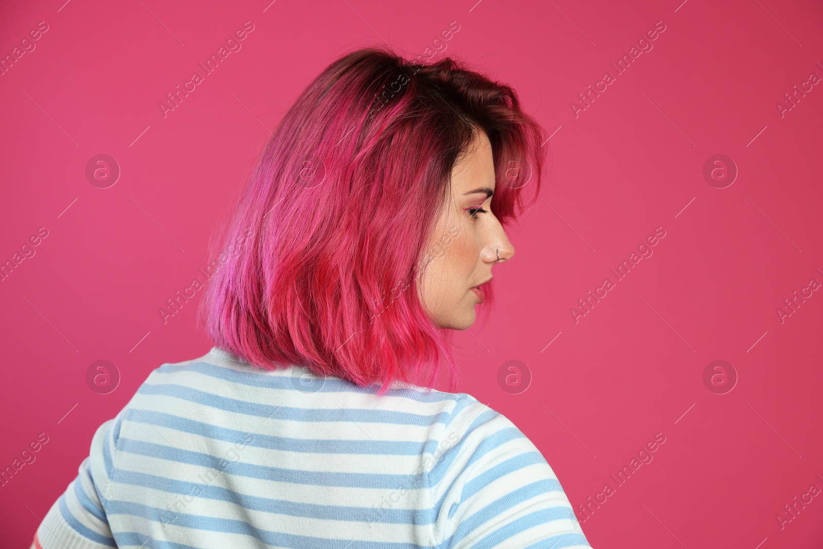 Beautiful woman with bright dyed hair on pink background Photo of Beautiful woman with bright dyed hair on pink background