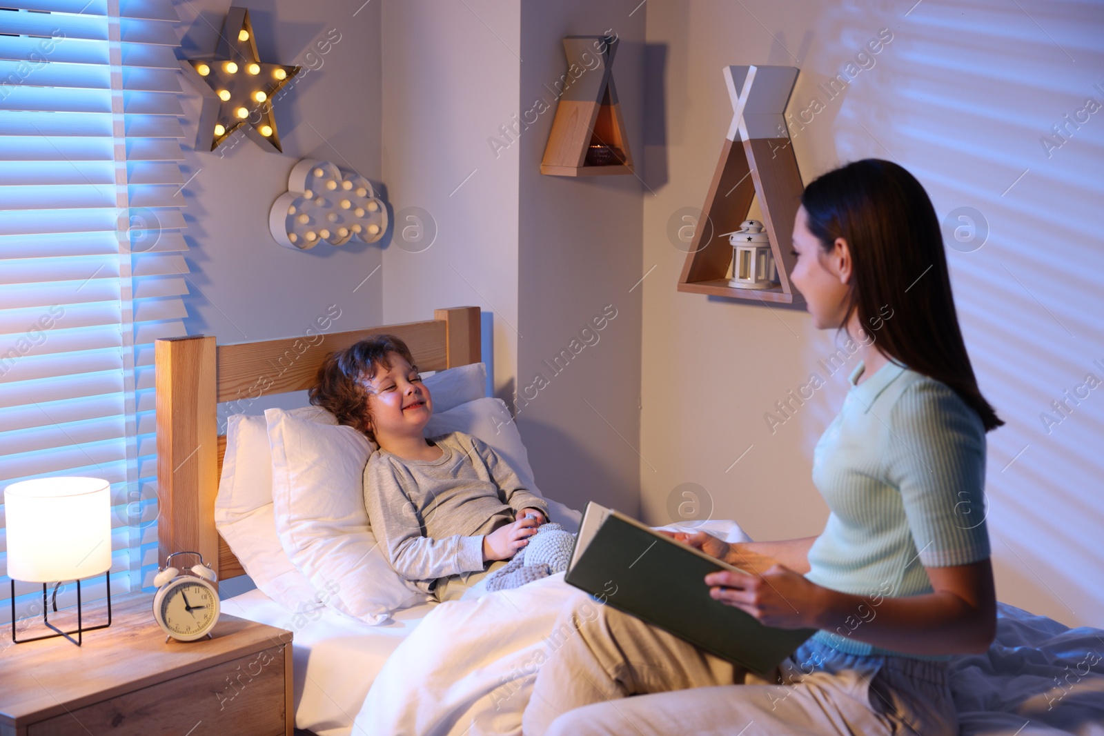Mother reading bedtime story to her son at home Photo of Mother reading bedtime story to her son at home