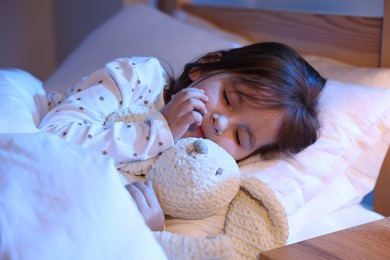 Photo of Little girl sleeping in bed at home
